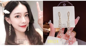 Detailed view of long tassel pearl earrings with S925 silver needles in gold plating