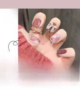 Macro detail of marble-textured press-on nails with 3D bows and micro pearls decor