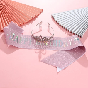 Pink glitter Happy Birthday sash with silver rhinestone tiara on a pink decorative background