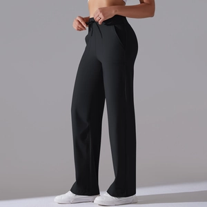 Detail of high-waist black yoga pants showing drawstring waist and side pockets