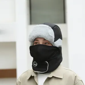 Detail of men's winter trapper hat with integrated face mask and grey fur trim