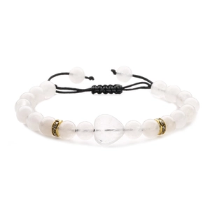 Close-up of white beads bracelet featuring a heart-shaped pendant and gold spacers
