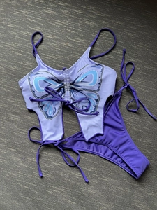 Detail of lavender butterfly shaped bikini top with blue patterns and purple side-tie bottoms