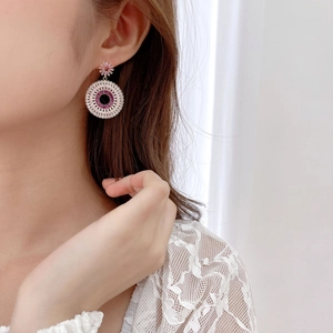 Close-up of S925 silver hoop earrings with gradient pink and purple zircon stones