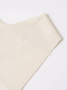 Detailed view of the fine ribbing on the neck of this off-white knitted vest top