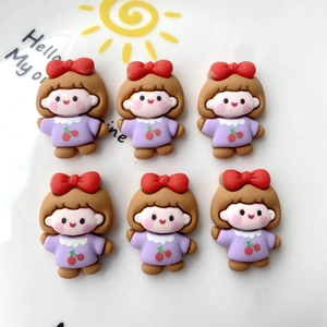 Flat lay of cute cartoon girl resin charms for DIY phone cases and hair accessories