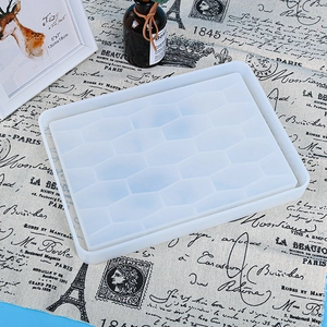 Macro detail of a honeycomb square resin tray silicone mold on a vintage tablecloth