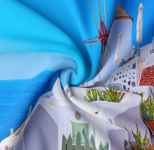 Detailed macro view showing the silky texture and Santorini print of the wall tapestry