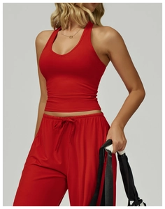 Detail view of red halter yoga top and matching drawstring pants on model