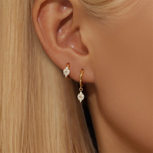 Close-up of gold-plated S925 silver hoop earrings with zircon flowers on ear
