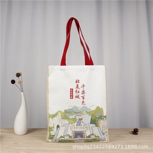 Detail of Lily Letter canvas tote bag featuring red handles and historical architecture print
