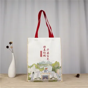 Detail of Lily Letter canvas tote bag featuring red handles and historical architecture print