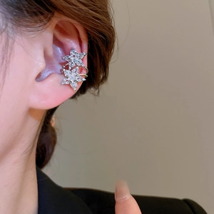 Detailed view of double star ear cuff with sparkling cubic zirconia on model