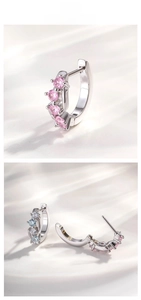 Detail of silver geometric hoop earrings featuring pink and blue zircon stones in claw setting