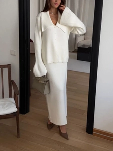Mirror selfie showing the elegant cream-white knitted cardigan and long skirt set