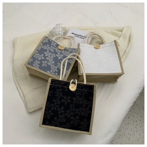 Detailed view of canvas lunch bags with floral prints and distinctive wooden button closures