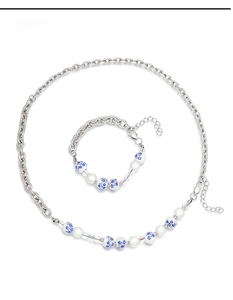 Detail of necklace and bracelet set with blue and white porcelain beads and silver chain
