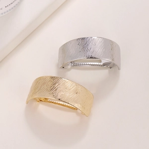 Golden and silver brushed metal spring clips with minimalist arc design for ponytails