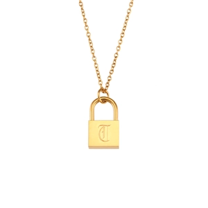 Detailed view of golden padlock pendant with gothic letter T on fine link chain