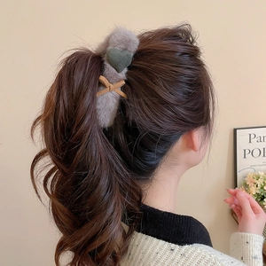 Detail of gray plush heart hair claw clip holding a ponytail for a cozy everyday look