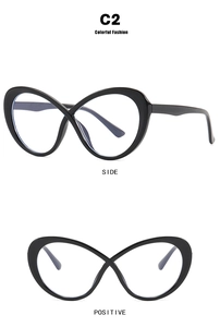 Close-up of black oval glasses frame with unique infinity cross bridge design