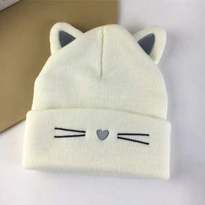 White knit cat ear beanie with embroidered whiskers and soft ribbed texture for winter