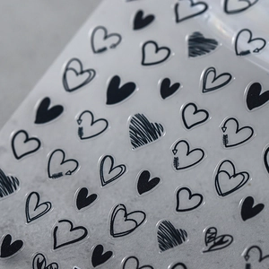 Matte heart nail stickers featuring minimalist black sketch patterns on transparent film