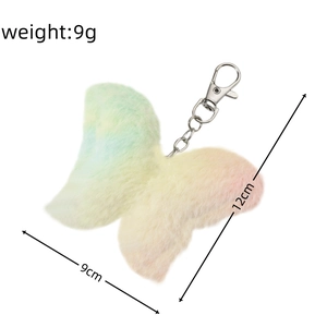 Macro detail of plush butterfly pendant with gradient pastel colors and silver lobster clasp