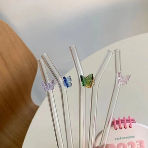 Set of four clear bent glass straws with colorful 3D butterfly ornaments for juices