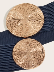 Detail of navy blue elastic waist belt with textured gold circular metal buckle