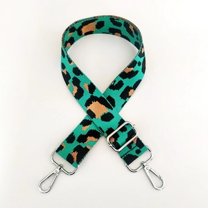 Detail of adjustable leopard print bag strap in green and brown with silver hardware