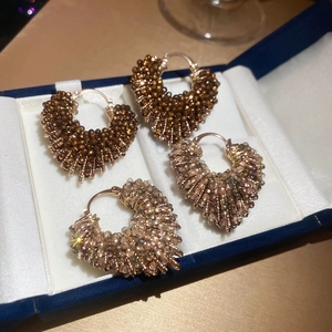 Detailed close-up of handmade crystal beaded heart earrings in coffee and champagne colors
