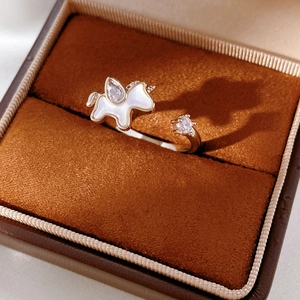 Detail of unicorn ring with cubic zirconia and pearl inlay in jewelry box