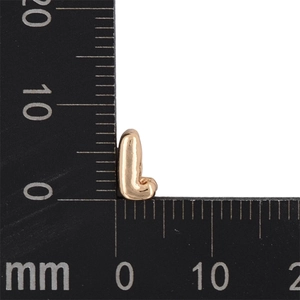 Detailed size measurement of a gold letter L pendant showing 10mm height on a ruler