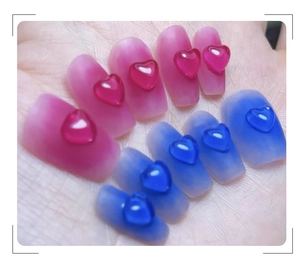 Detail of pink and blue gradient nail art tips with 3D resin jelly heart charms