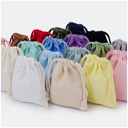 Variety of small colorful velvet drawstring pouches stacked for jewelry gift packaging