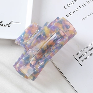 Close-up of 10cm rectangular marble acetate hair claw clip with golden metal spring