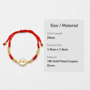 Detailansicht des roten gewebten Armbands mit Zirkonia-Anhänger und FE-Gold-Charme