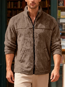 Close-up of men's brown fleece jacket with high collar and zipper in a cozy library setting