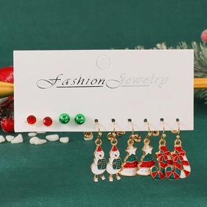 5-pair Christmas earring set with snowman, tree, and candy cane charms on a display card