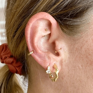 Golden micro-pave zircon hoop earrings and cuff set with geometric wave patterns