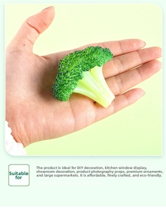 Realistic artificial broccoli model held in hand to show scale for decor and props