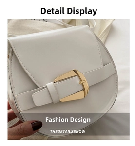 Detail shot of the white saddle bag featuring a distinctive large gold metal buckle