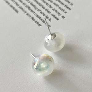 Iridescent star shell pearl stud earrings with S925 sterling silver needles on a paper base
