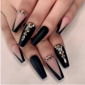 Detail of matte black and nude pink coffin press-on nails with sparkling rhinestones