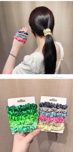 Detail of satin scrunchies set with a model wrist display and card packaging