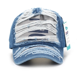 Distressed blue denim baseball cap with frayed hole details and vintage washed style