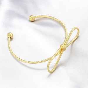 Elegant gold plated bow knot open bangle with a polished minimalist twisted design