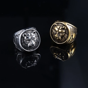 Close-up of gold and silver lion head rings with high-quality metal textures and details