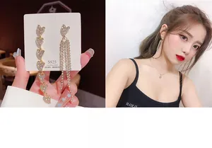 Detail of luxury asymmetric heart tassel earrings with S925 silver needles for women